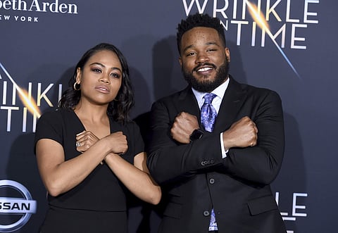 Zinzi Evans, left, and Ryan Coogler gesture the 'Wakanda Forever' symbol from the film 'Black Panther' as they arrive at the world premiere of 'A Wrinkle in Time' at the El Capitan Theatre. | AP