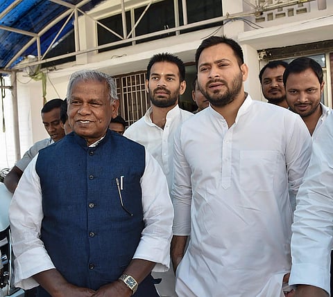 Rashtriya Janata Dal RJD leader Tejashwi Yadav with former Bihar Chief Minister and Hindustani Awam Morcha Secular leader Jitan Ram Manjhi leave after attending a meeting in Patna on Wednesday. | PTI