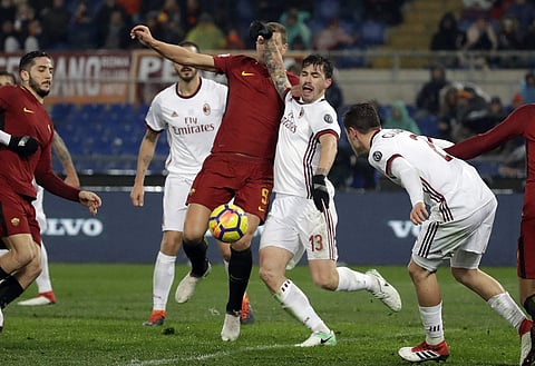 AC Milan's Alessio Romagnoli and Roma's Edin Dzeko vie for the ball during a Serie A soccer match. | AP