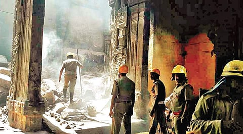 The fire and rescue services personnel are still seen putting out the fire that broke out in the East Tower of Meenakshi Amman Temple in Madurai on Saturday morning | EPS