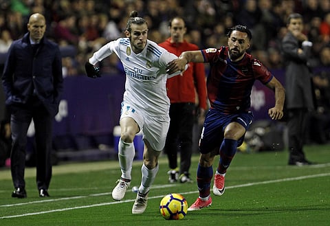Real Madrid's Gareth Bale, left, duels for the ball with Levante's Ivan Lopez Alvarez during the Spanish La Liga soccer match between Levante and Real Madrid at the Ciutat de Valencia stadium. | AP