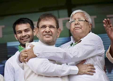 File photo of RJD chief Lalu Prasad Yadav with rebel Janata Dal-United JD-U leader Sharad Yadav during the 'BJP bhagao desh bachao' rally at Gandhi Maidan in Patna.| PTI