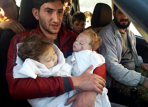 Abdel Hameed Alyousef holds his twin babies who were killed during a suspected chemical weapons attack. (Photo | AP)