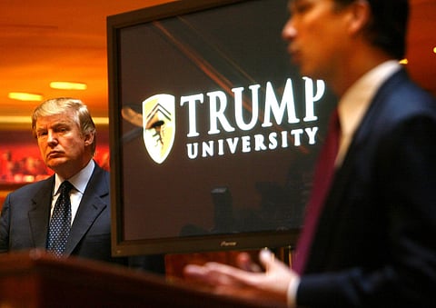 In this Monday May 23, 2005 file photo Donald Trump, left, listens as Michael Sexton introduces him to announce the establishment of Trump University at a press conference in New York. (Associated Press)
