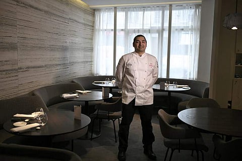 Lebanese chef Alan Geaam poses in his restaurant 'Alan Geaam' on February 7, 2018 after he received a single star from the Michelin guide for his restaurant in Paris. | AFP