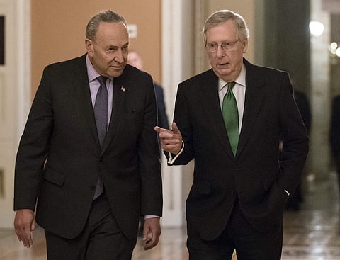 Senate Minority Leader Chuck Schumer, D-N.Y., left, and Senate Majority Leader Mitch McConnell, R-Ky., walk to the chamber after collaborating on an agreement in the Senate on a two-year, almost $400 billion budget deal that would provide Pentagon and dom