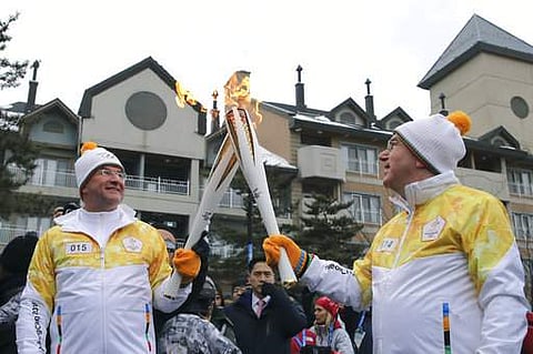 President of the International Olympic Committee Thomas Bach takes, right, and United Nations President of the General Assembly Miroslav Lacjak take part in the Pyeongchang 2018 Torch Relay ahead of the Winter Games in Pyeongchang, South Korea. (AP)