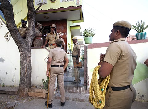 Policemen stationed in front of the house where the alleged police encounter happened in Madurai on Thursday. (EPS | KK Sundar)