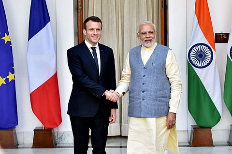 Prime Minister Narendra Modi shakes hands with French President Emmanuel Macron before their meeting at Hyderabad House in New Delhi on Saturday. | PTI
