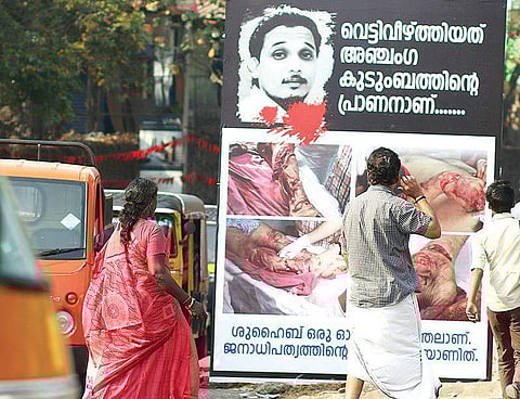 Flex board displaying gory photographs of slain Youth Congress worker Shuhaib in Kannur | Express Photo
