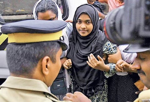In this file photo, Hadiya is seen being taken to the domestic terminal of the Cochin International Airport by security officers, at Nedumbaserry, 26, November 2017 | Express