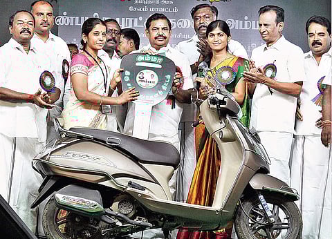Chief Minister Edappadi K Palaniswami handing over a bike to a beneficiary as part of the Amma Scooter Scheme, in Salem on Monday | Express