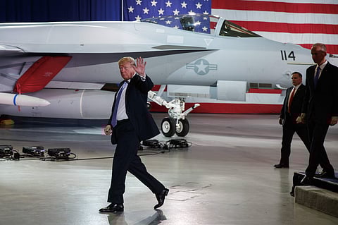 President Donald Trump waves as he walks off after participating in a roundtable discussion on tax policy at the Boeing Company. | AP