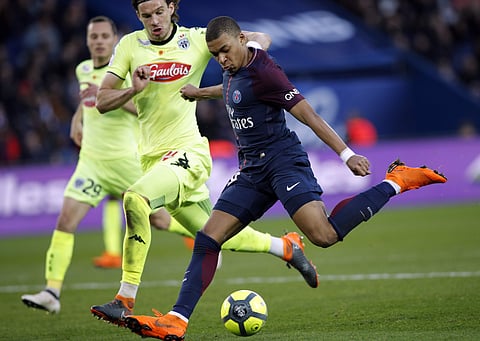 PSG's Kylian Mbappe, right, kicks the ball past Angers' Mateo Pavlovic during the French League One soccer match between Paris Saint-Germain and Angers at the Parc des Princes Stadium, in Paris, France, Wednesday, March 14, 2018. | AP