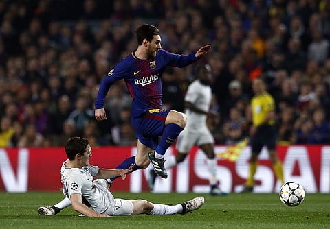 Barcelona's Lionel Messi leaps over Chelsea's Andreas Christensen during the Champions League round of sixteen second leg soccer match against Chelsea. | AP