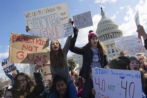 Warning that their futures are being stolen from them, tens of thousands of young people across the U.S. walked out of school to demand action on gun violence. (Photo | AFP)