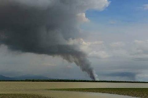 File photo: Smoke is seen billowing in an area inland in Myanmar's Rakhine state as seen from the Bangladeshi shore of the Naf river on September 14, 2017. | AFP