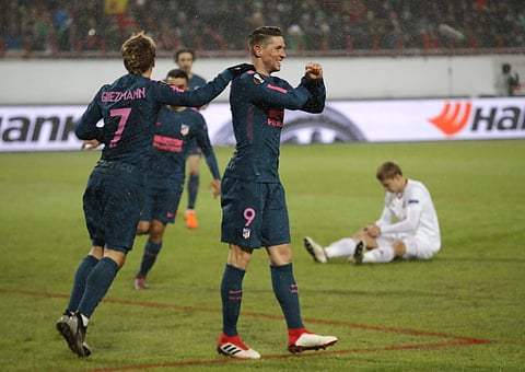 Atletico's Fernando Torres celebrates with team mates after scoring during the Europa League, round of 16 second leg soccer match between Lokomotiv Moscow and Atletico Madrid, in Moscow, Russia, Thursday, March 15, 2018. | AFP