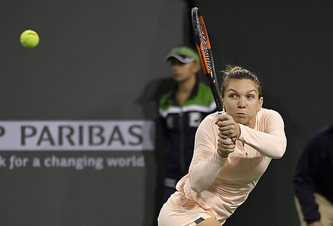 Simona Halep, of Romania, returns a shot against Naomi Osaka, of Japan, during the semifinals at the BNP Paribas Open tennis tournament | AP