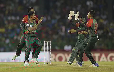 Bangladesh's Mustafizur Rahman, left, celebrates the dismissal of Sri Lanka's Dasun Shanaka with teammates during their second Twenty20 cricket match in Nidahas triangular series in Colombo, Sri Lanka, Friday, March 16, 2018. | AP