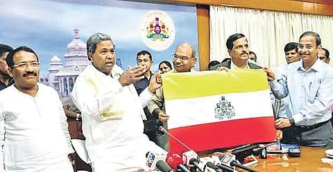CM Siddaramaiah with the newly-released Karnataka state flag