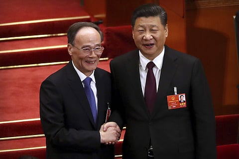 Chinese President Xi Jinping shakes hands with Wang Qishan after Wang was elected Vice-President. (Photo | AP)