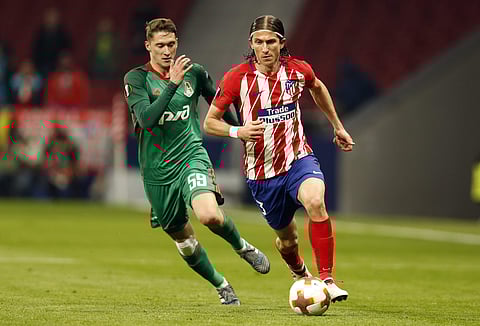 Atletico Madrid's Filipe Luis, right, is challenged by Lokomotiv's Aleksei Miranchuk during the Europa League Round of 16 first leg soccer match between Atletico Madrid and Lokomotiv Moscow at the Metropolitano stadium in Madrid, Thursday, March 8, 2018.