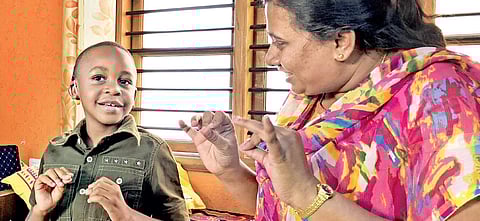 Apulihe Bohela with his therapist at Vani Pradhan Kendra. (Below) Kids during a yoga session I sridevi S