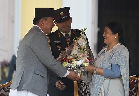 Nepal's president, Bidhya Devi Bhandari, right, who was elected Tuesday to a second term receives flowers from vice president Nanda Kishor Pun during the oath of office ceremony at the President Residence in Kathmandu, Nepal, Wednesday, March 14, 2018. Bh