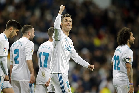 Real Madrid's Cristiano Ronaldo, center, celebrates after scoring his third goal during a Spanish La Liga soccer match against Girona. | AP