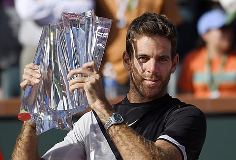 Juan Martin del Potro, of Argentina, holds up his trophy after defeating Roger Federer, of Switzerland, during the men's final at the BNP Paribas Open tennis tournament. | AP