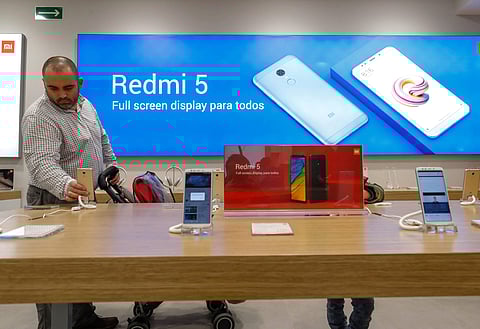 A customer looks at products at a Xiaomi shop in a shopping mall in Barcelona, Spain |REUTERS