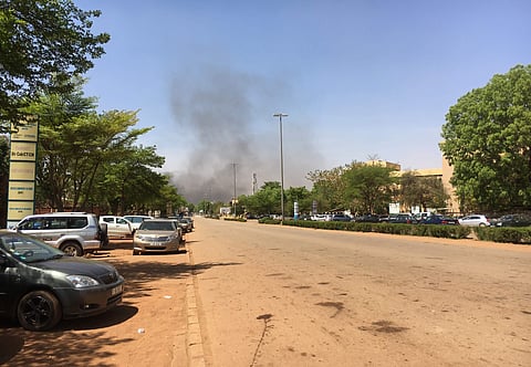 Smoke can be seen rising in the distance in central Ouagadougou, Burkina Faso, Friday March 2, 2018. | AP