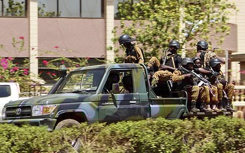 Troops ride in a vehicle near the French Embassy in central Ouagadougou, Burkina Faso, Friday March 2, 2018. | AP
