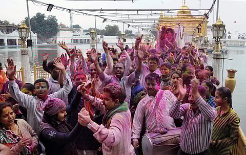 People celebrating Holi in Golden Temple, Amritsar. (Photo | PTI)