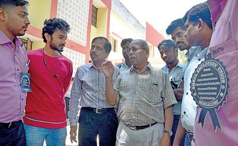 BMRCL staffers have a discussion outside the Labour Commissioner’s office in Yeshwanthpur on Monday | Pushkar V