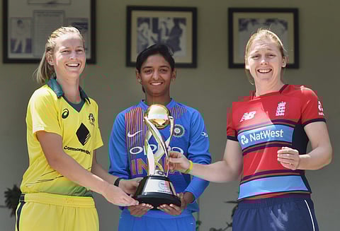 Indian women's cricket team captain Harmanpreet Kaur flanked by Australia's team captain Meg Lanning and England team captain Heather Knight with the winner's trophy ahead of the Women's T20I Tri-series at Brabourne stadium in Mumbai on Wednesday. | PTI