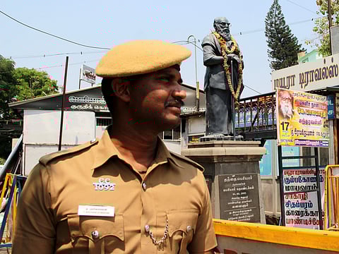 Policeman guarding a Periyar statue in Tamil Nadu. (EPS)