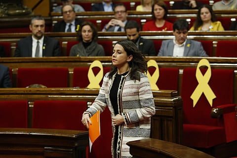 Ciudadanos party leader Ines Arrimadas walks past yellow ribbons placed on seats in support of Catalonian politicians who have been jailed on charges of sedition as she prepares to speak in the parliament during a parliamentary session. | AP