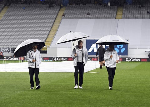 Umpires Ron Knight, left, Paul Reiffel and Bruce Oxenford walk after checking the pitch as rain continues to delay play between New Zealand and England during the first Test in Auckland, New Zealand, Saturday, March 24, 2018.| AP