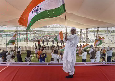 Social activist Anna Hazare waves a tri-colour during his indefinite hunger strike in New Delhi on Saturday. (Photo | PTI)