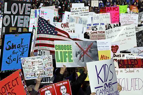 Crowds of people hold signs at the 'March for Our Lives' rally in support of gun control. (AP)