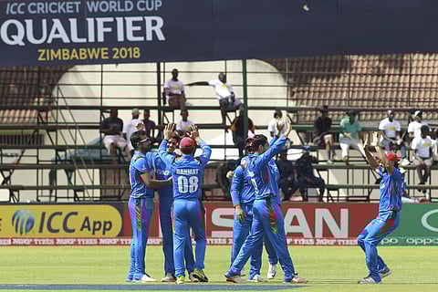 Afghanistan players celebrate the wicket of West Indies batsman Christopher Gayle during their World Cup qualifier at Harare Sports Club in Harare Sunday, March, 25, 2018. | AP