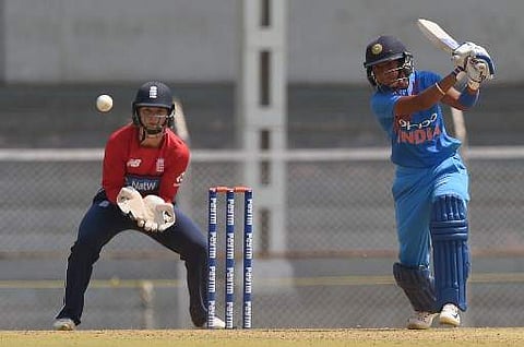 England wicketkeeper Amy Jones (L) reacts as Indian cricketer Harmanpreet Kaur plays a shot during the third cricket match of the women's Twenty20 (T20) Tri-Series between India and England at Brabourne Stadium in Mumbai on March 25, 2018. | AFP