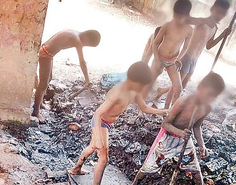 Students of CSI Corley School Hostel on M.E.S. Road cleaning up mud in the drain | Express