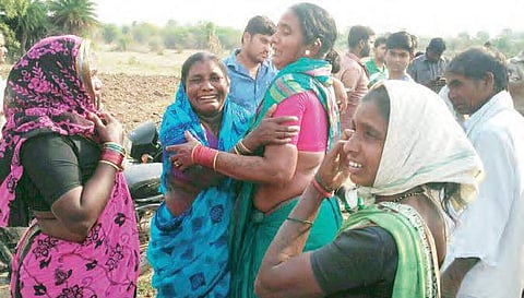 Grieving relatives of those who perished in the freak accident wherein an auto-rickshaw fell into an open wall, in Nizamabad on Sunday | Express photo