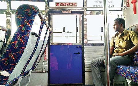 The emergency exit door near the last row of seats. A hammer is also provided to break the window glass in case of emergency | S DINESH