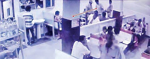 The CCTV video grab of Mohan Reddy meeting his family members inside a hotel near the court premises. Also seen are his escort policemen |EXPRESS
