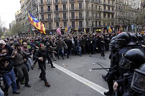 Catalan Mossos d'Esquadra regional police officers clash with pro-independence supporters trying to reach the Spanish government office in Barcelona. | AP File