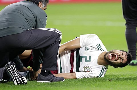 A member of the staff checks on Mexico defender Néstor Araujo after Araujo suffered a leg injury in the first half of a friendly match against Croatia in Texas. (AP)